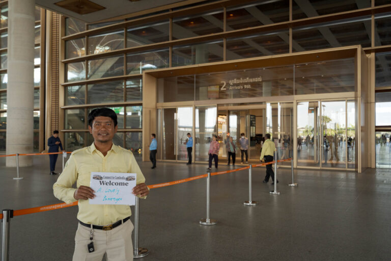 Phnom Penh airport transfer driver meeting passenger in arrivals area with name sign