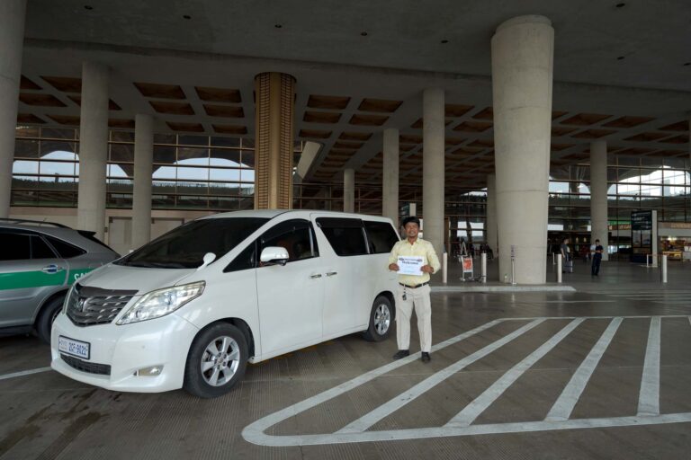 driver with toyota alphard at arrivals area of KTI Airport waiting for a pick up of a passenger